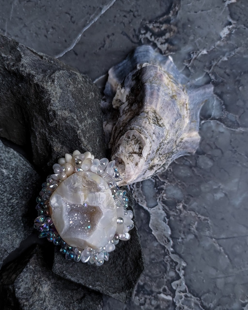 Brooch 'Oyster • collection ONLY
4,5 x 5,3 cm

° 13 000 ₽ °

The work uses 42 shades and 13 types of beads:

MIYUKI Long Magatama
MIYUKI Long Drop
MIYUKI Drops  3,2 mm,  2,8 mm
MIYUKI Delica  11/0
PRECIOSA Charlotte Cut  15/0,  17/0
PRECIOSA Drops  2/0
TOHO Magatamas  3mm
TOHO Round 15/0, 3/0
TOHO Demi Round  8/0,  11/0

And also:

Crazy Horse Leather
Semi-finished agate slice

Another version of a piece of stone chipped from a rock overgrown with beautiful living marine organisms, but this time in a delicate, pearly-creamy color scheme.

____

Брошь 'Oyster • коллекция ONLY
4,5 x 5,3 см

° 13 000 ₽ °

В работе использовано 42 оттенкa и 13 видов бисера:

MIYUKI Long Magatama
MIYUKI Long Drop
MIYUKI Drops  3,2 mm,  2,8 mm
MIYUKI Delica  11/0
PRECIOSA Charlotte Cut  15/0,  17/0
PRECIOSA Drops  2/0
TOHO Magatamas  3mm
TOHO Round 15/0, 3/0
TOHO Demi Round  8/0,  11/0

А также:

Кожа Crazy Horse
Полубработанный срез агата

Ещё одна версия обросшего живыми прекрасными морскими организмами кусочка отколотого от скалы камня, но на этот раз в нежной, жемчужно-сливочной цветовой гамме.